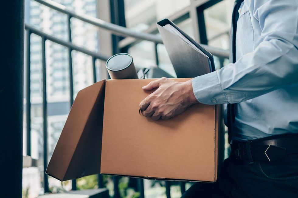 Fired worker carrying box out of office