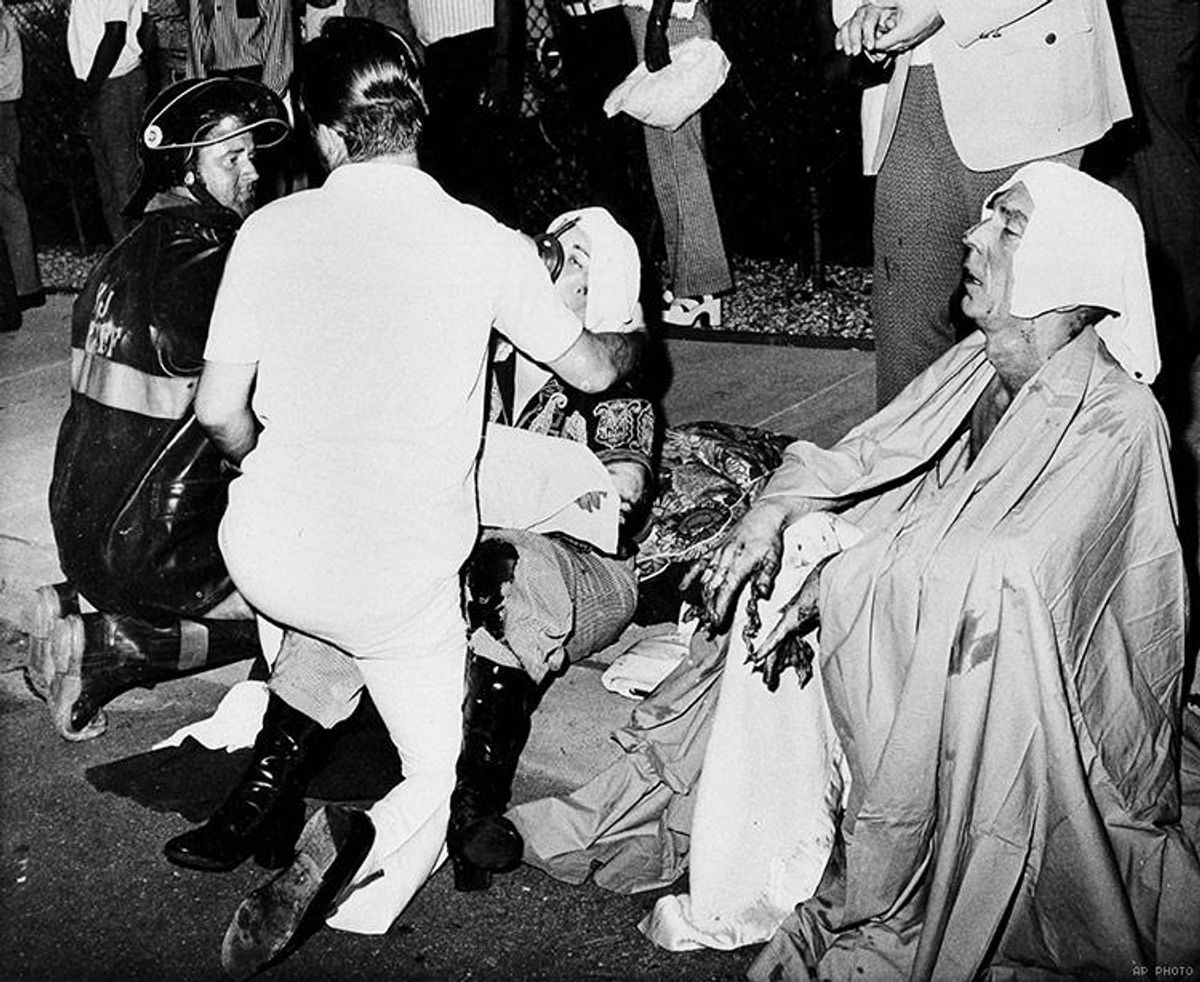 Firemen give first aid to survivors of a French Quarter fire that swept through a second story bar leaving 29 dead and 15 injured, June 25, 1973, in New Orleans. Several persons leaped to safety before the entire bar was engulfed in flames.