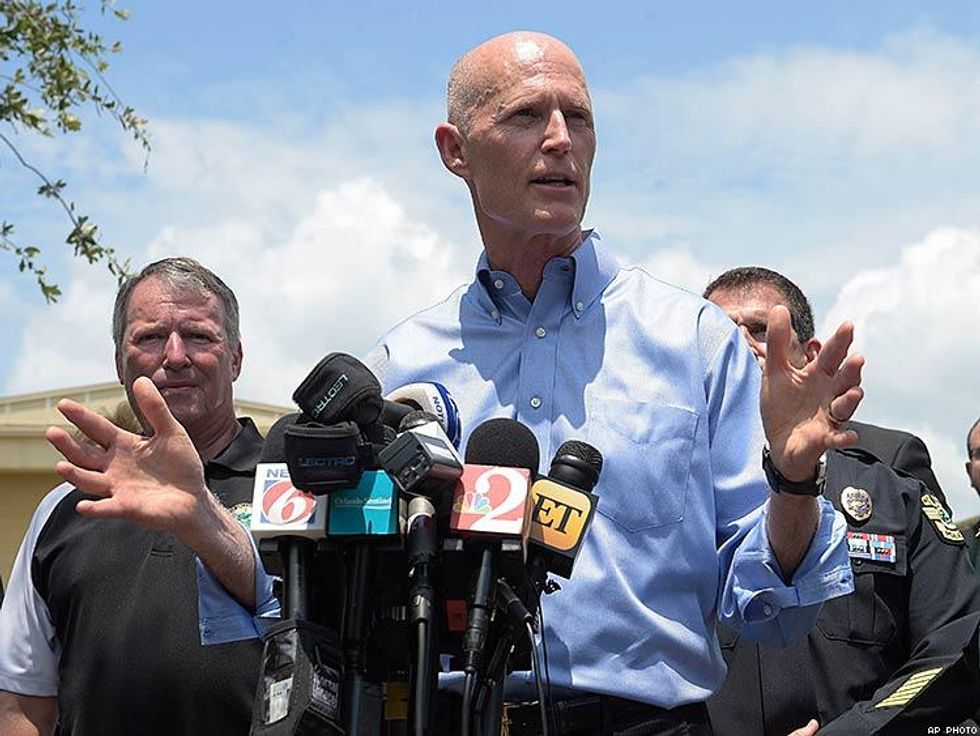 Florida Gov. Rick Scott, center, addresses reporters during a news conference