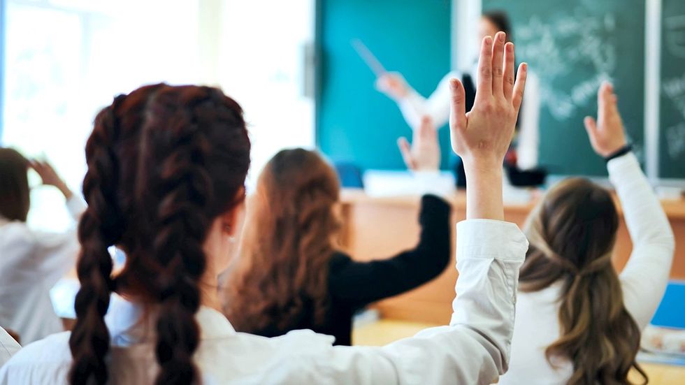 Florida students raising hand classroom teacher
