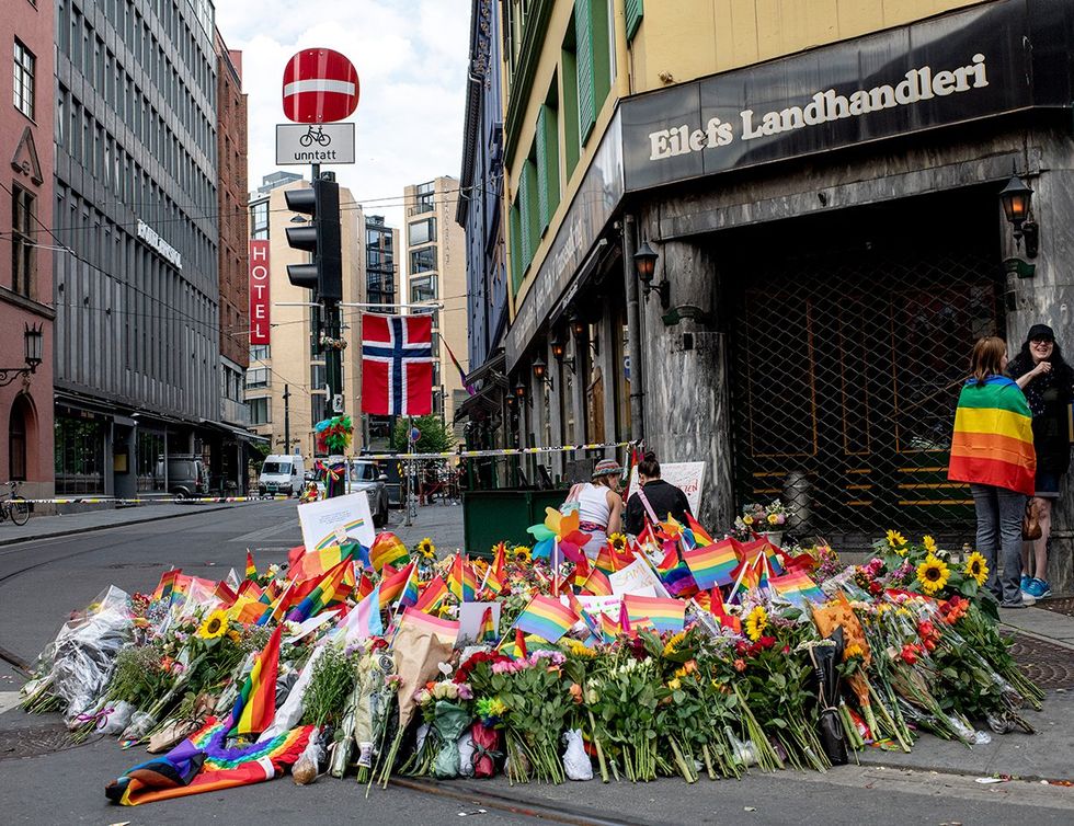 Flowers rainbow flags memorial shooting victims near popular gay club downton Oslo Norway