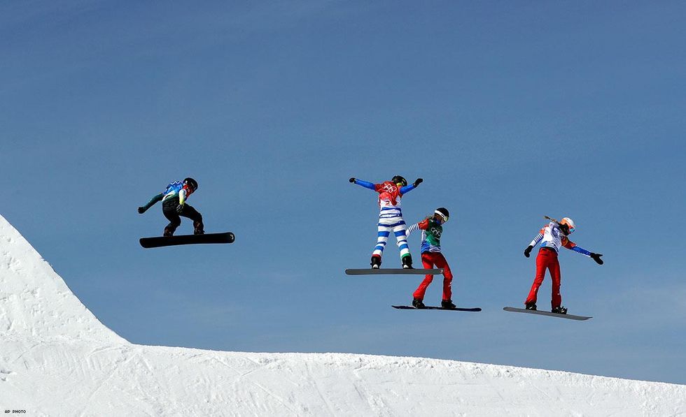 From left: out Olympian Belle Brockhoff, of Australia, Michela Moioli, of Italy, Chloe Trespeuch, of France, and Russian athlete Kristina Paul run the course during the women's snowboard cross semifinals at Phoenix Snow Park