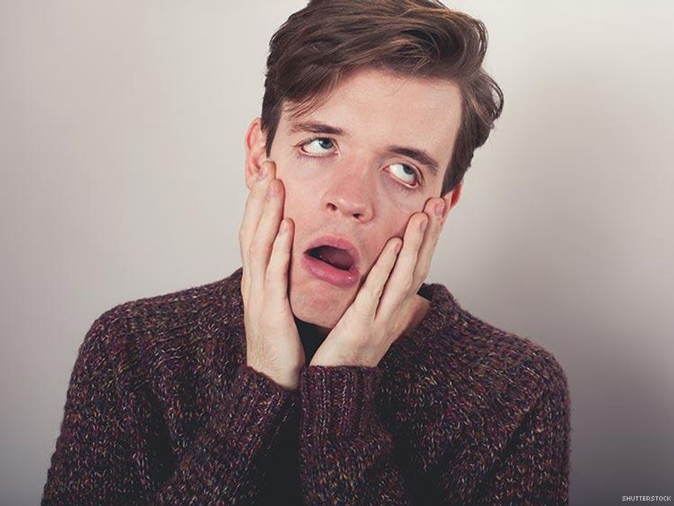 frustrated man pulling on his face