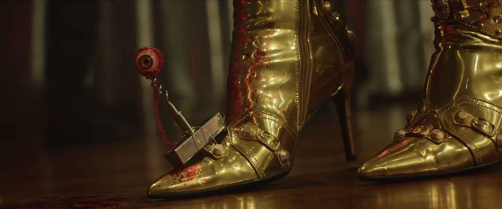 Gold boot with a eye on a spike