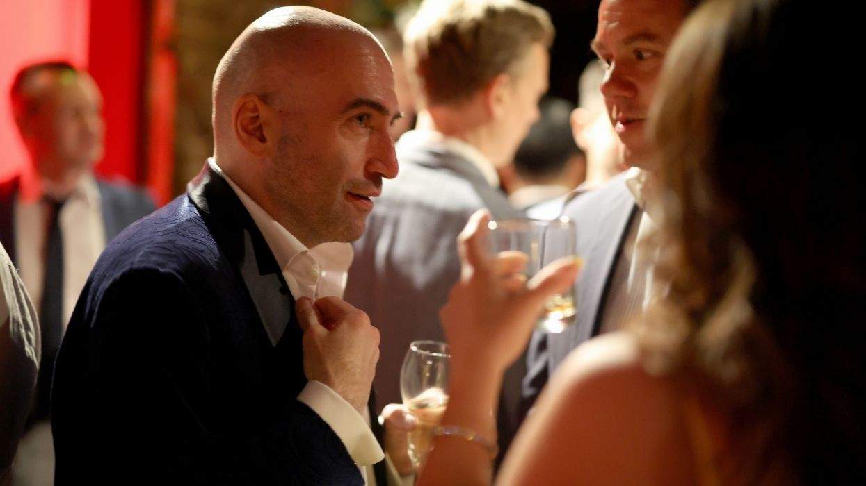 grindr ceo george arison speaking to guests at an exclusive white house correspondents' dinner party the company held