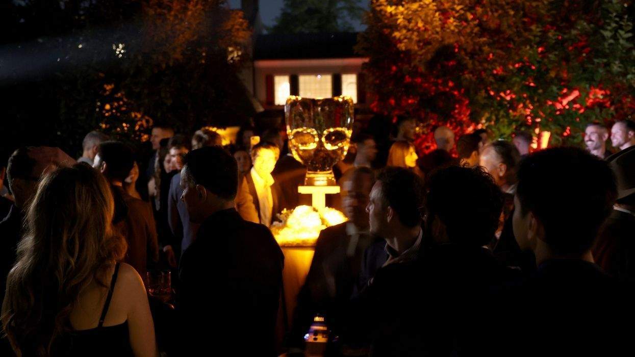 grindr ice sculpture with people surrounding it