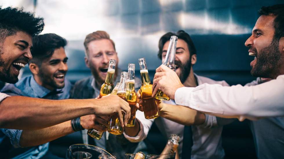 group of men toasting beers