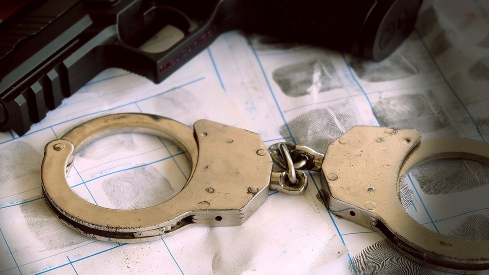 handcuffs gun fingerprints crime concept Minneapolis mass shooters killing LGBTQ punk rock show