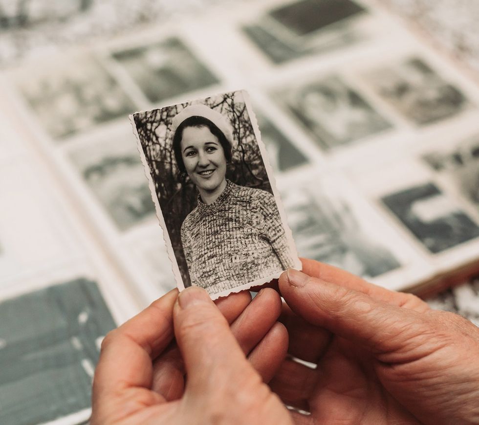 hands holding vintage photo album in the background