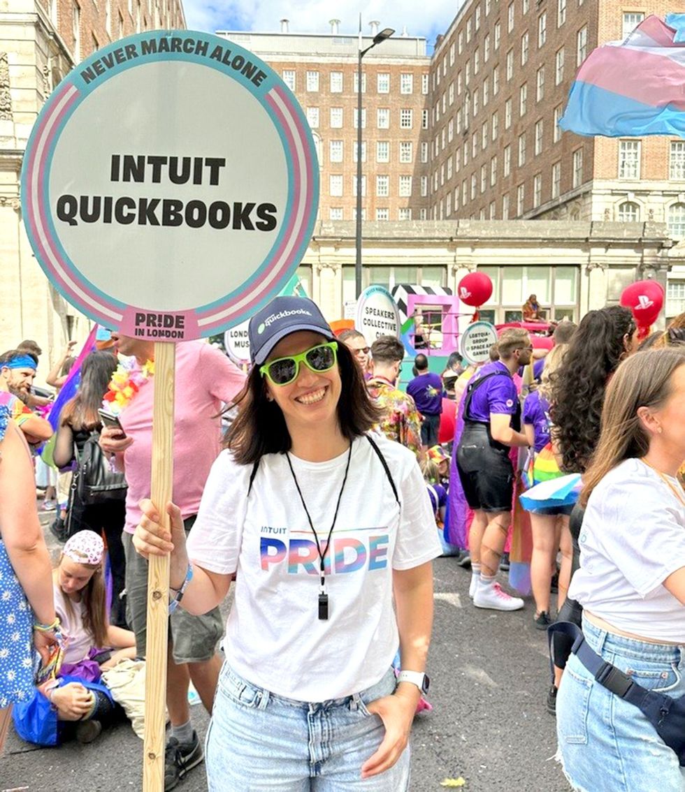 happy smiling person transgender flag never march alone sign attending lgbtq pride event