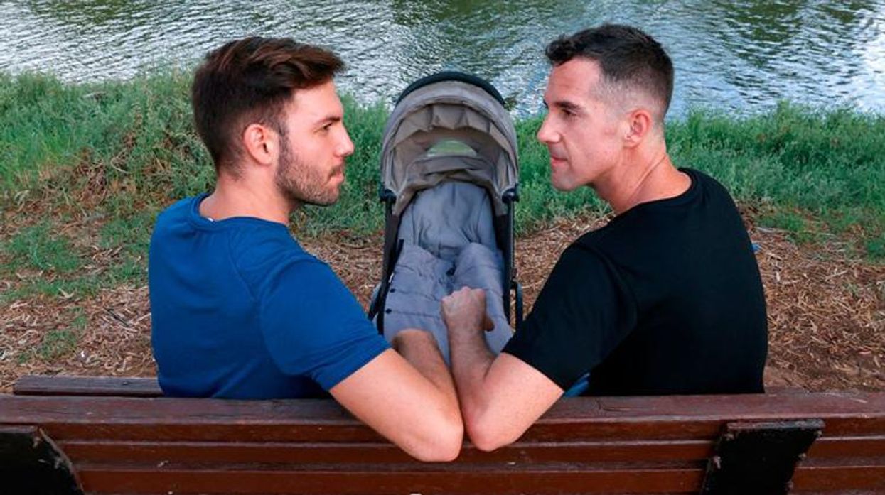 Harel Barak and his husband Yakir Kanneli pose for a picture with an empty stroller at a park in the Israeli coastal city of Tel Aviv.