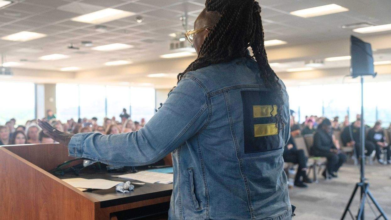 hrc president kelley robinson speaking to a crowd at baylor wearing an hrc denim jacket