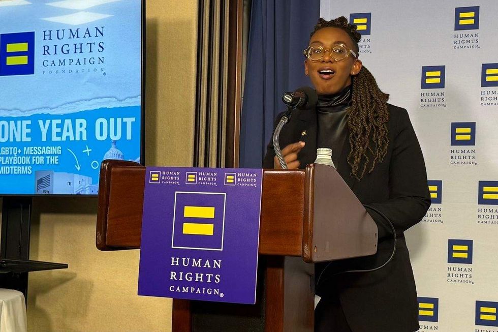hrc president kelley robinson standing at a lectern