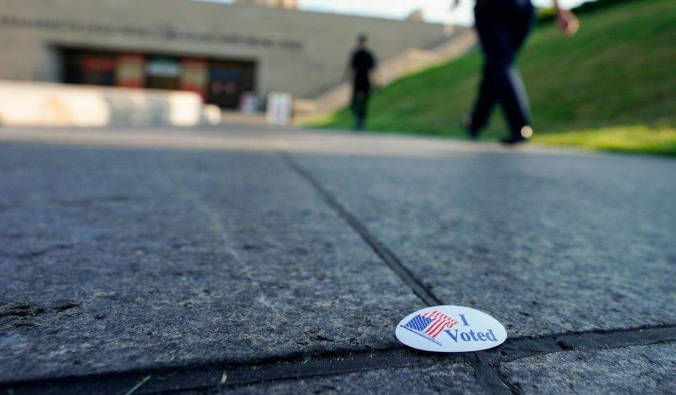 i voted sticker on a stone floor
