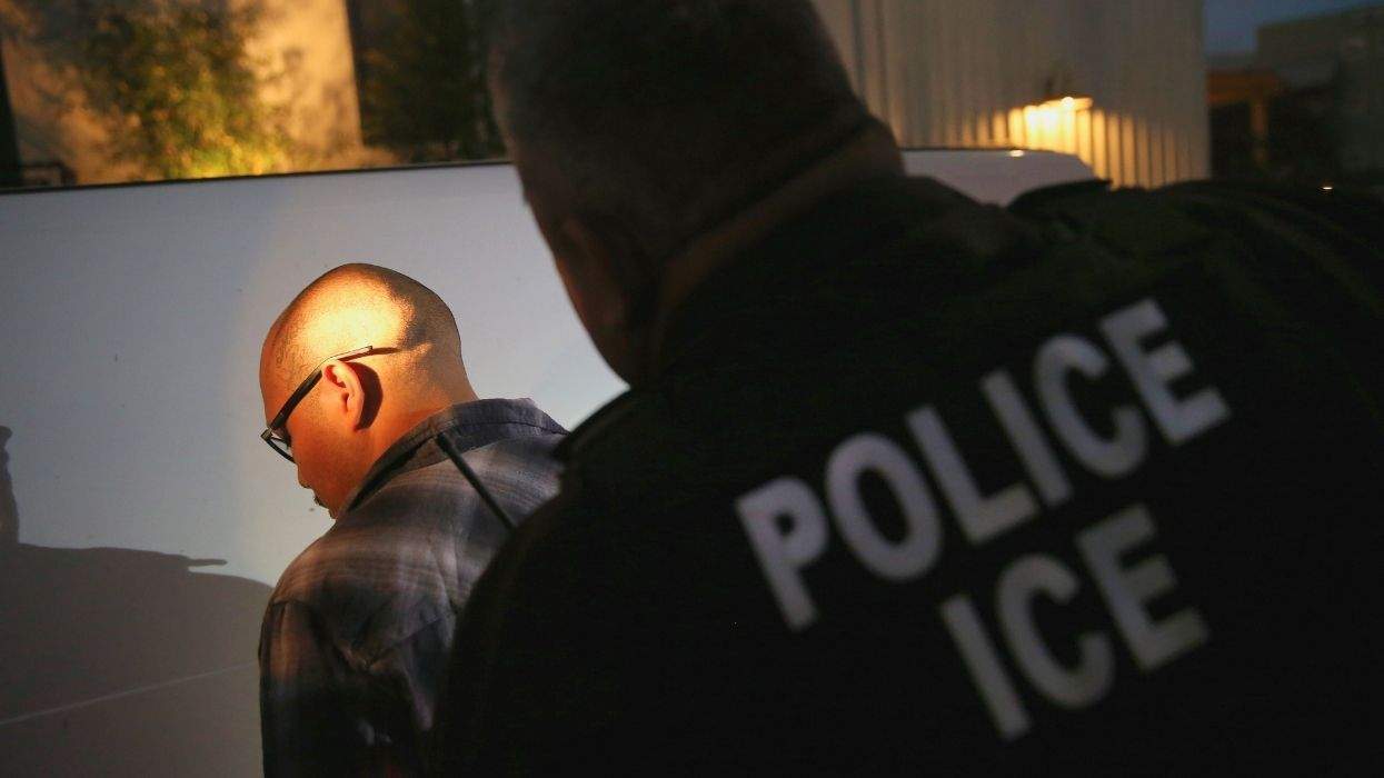 ice agent arresting a man