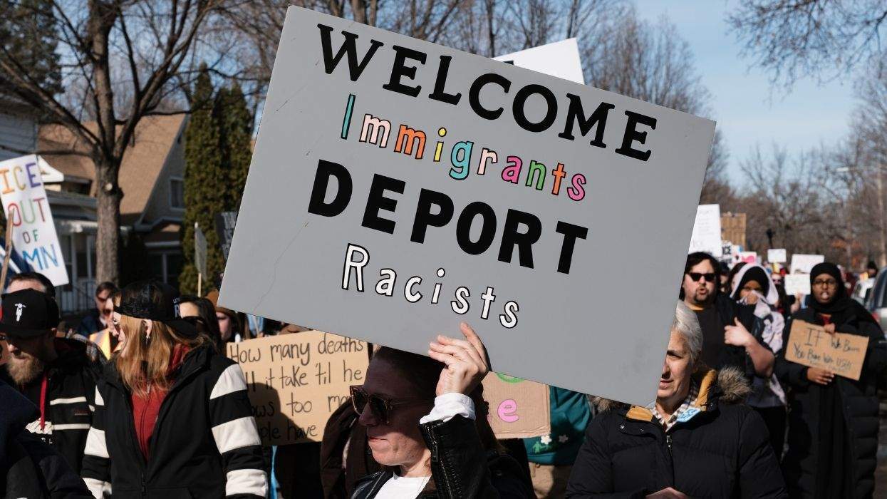 ice protest sign that reads welcome immigrants deport racists