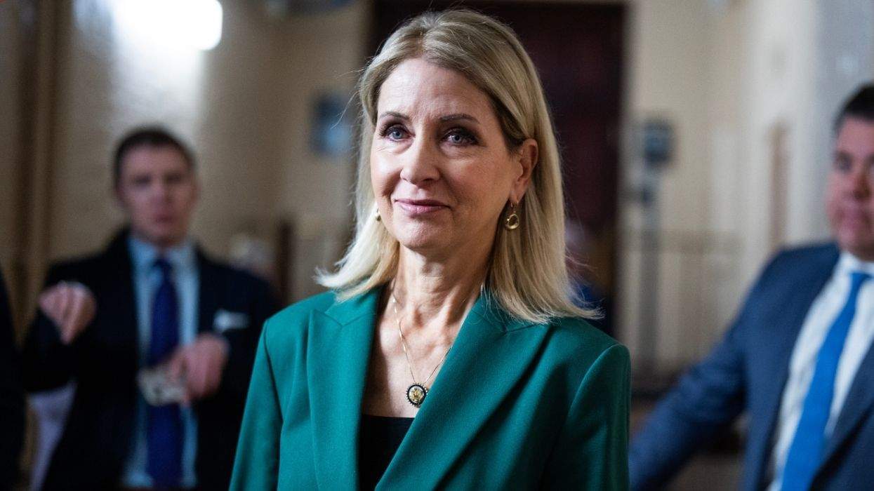 illinois rep. mary miller wearing a green blazer in the halls of Congress