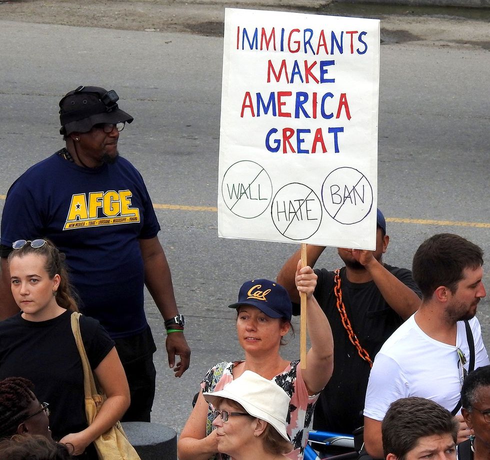 Immigrants make america great sign Peaceful Protest Against White Supremacy Violence New Orleans Louisiana