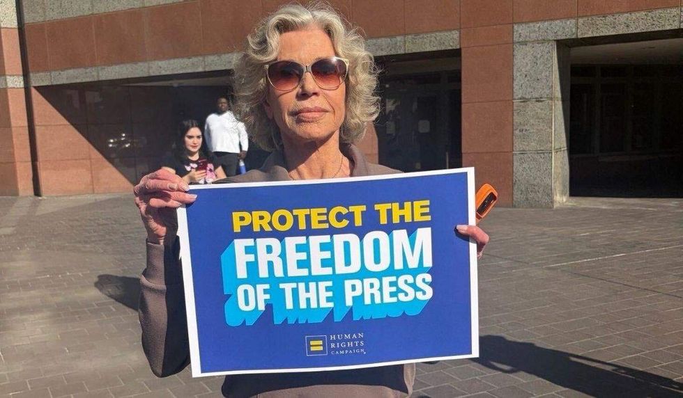 Jane Fonda holding HRC sign