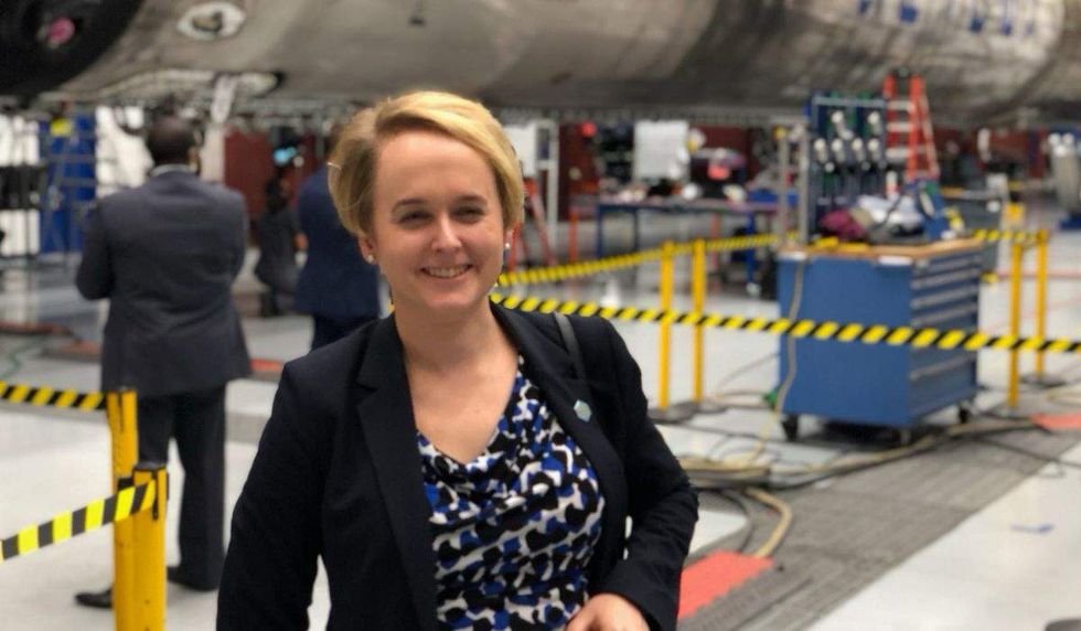 julia curlee in front of a rocket