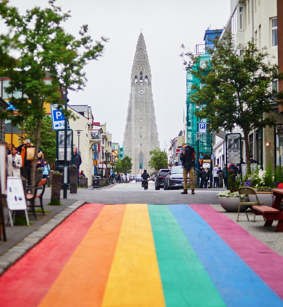 JULY 2024 People walking along Rainbow street approach road to Hallgrimskirkja Church Reykjavik Iceland