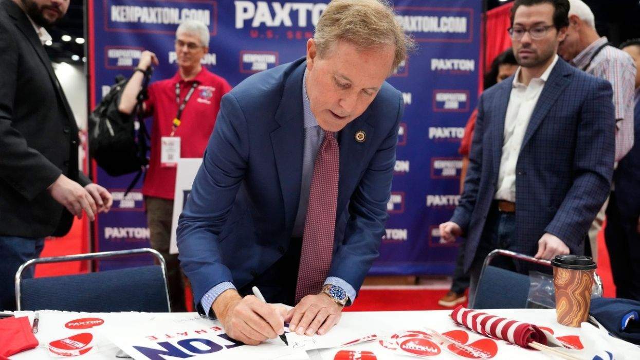 ken paxton autographing a campaign sign