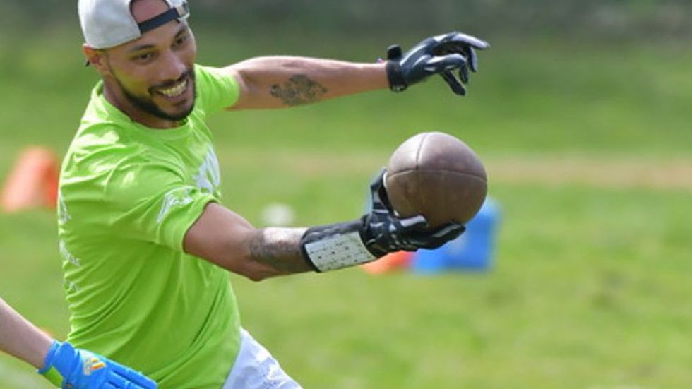 Kevin Davila reaching for a score in the National Gay Flag Football League
