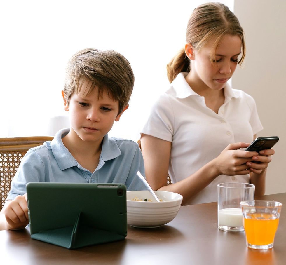 kids on electronic devices ipad cell phone breakfast table Upholding privacy connected world OPED Erica Portnoy