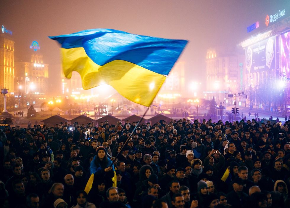 Kiev Ukraine 2013 large crowd waving country flag during revolution to support the integration of Ukraine into the European Union