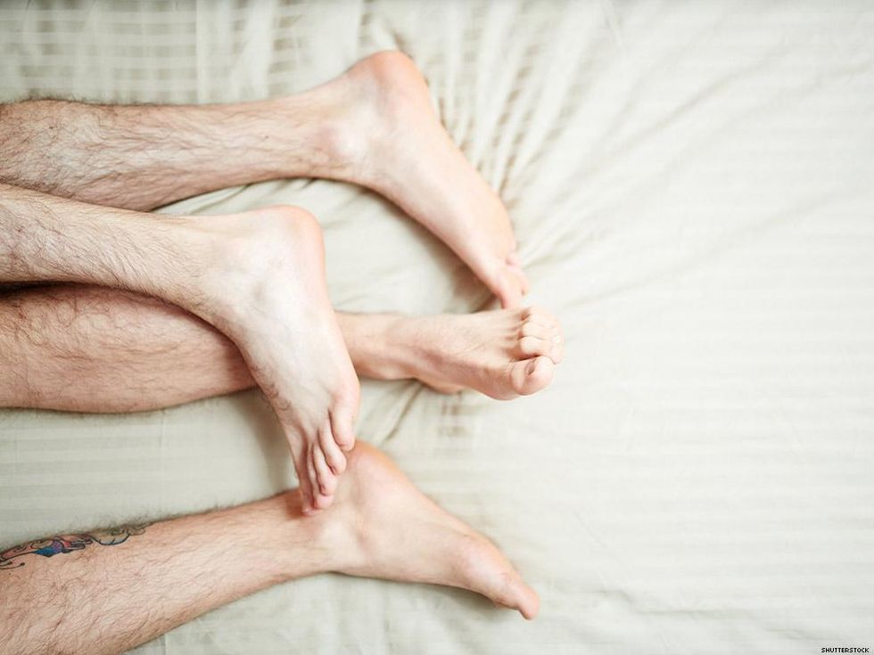 legs and feet on a bed