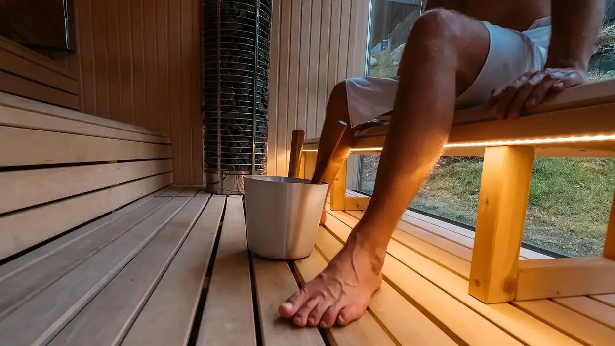 legs of a man sitting inside a sauna