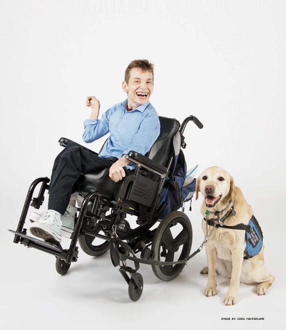 Lesbian disability activist Eva Sweeney in her wheelchair with her service dog at her side