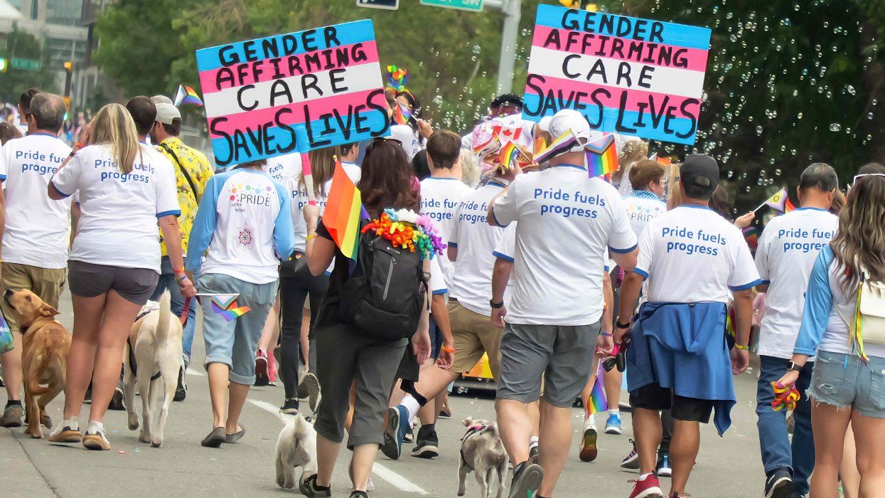 LGBTQIA pride march signs say gender affirming care saves lives shirts say pride fuels progress