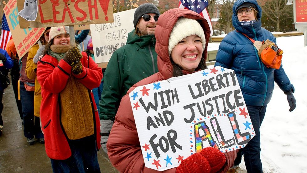 Liberty and Justice for all sign at International Womens Day 50501 protest Vermont State House in Montpelier
