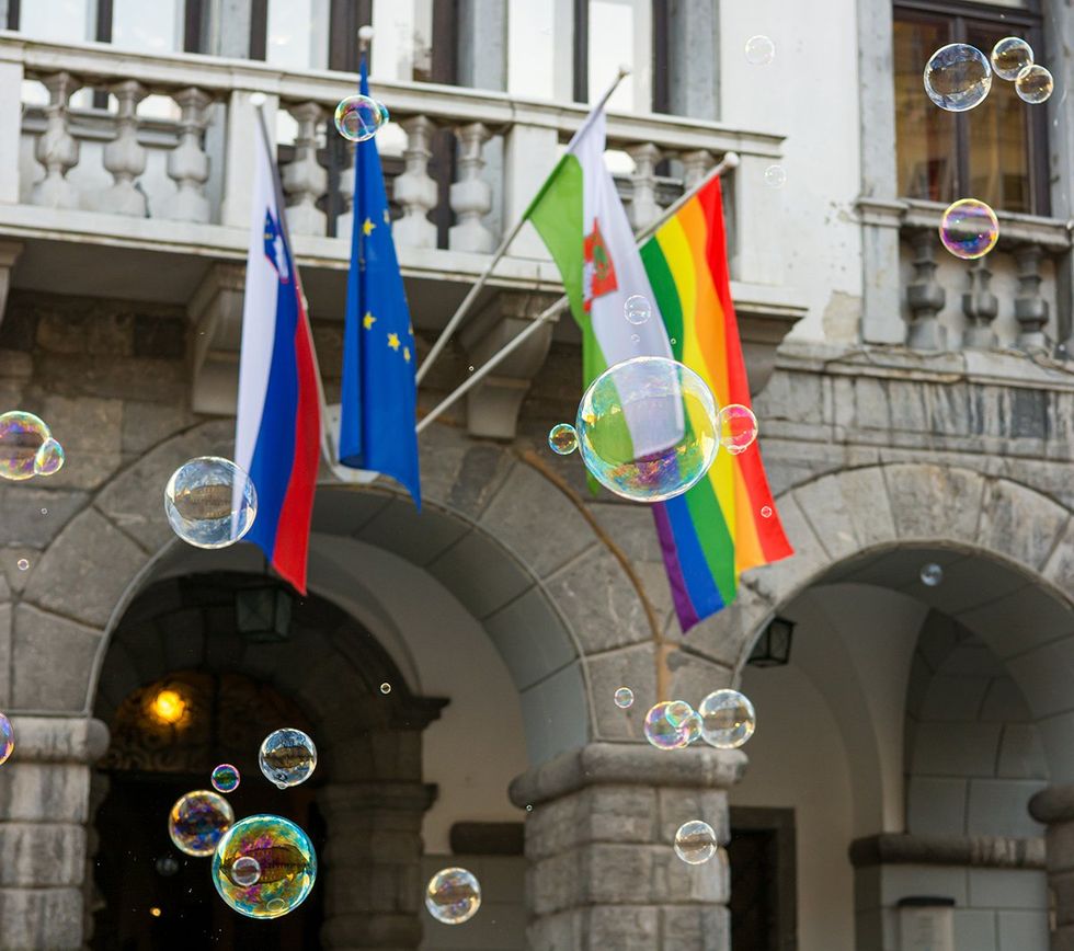 Ljubljana Slovenia 2016 bubbles floating in front of rainbow flag on city hall in support of LGBTQ equal rights