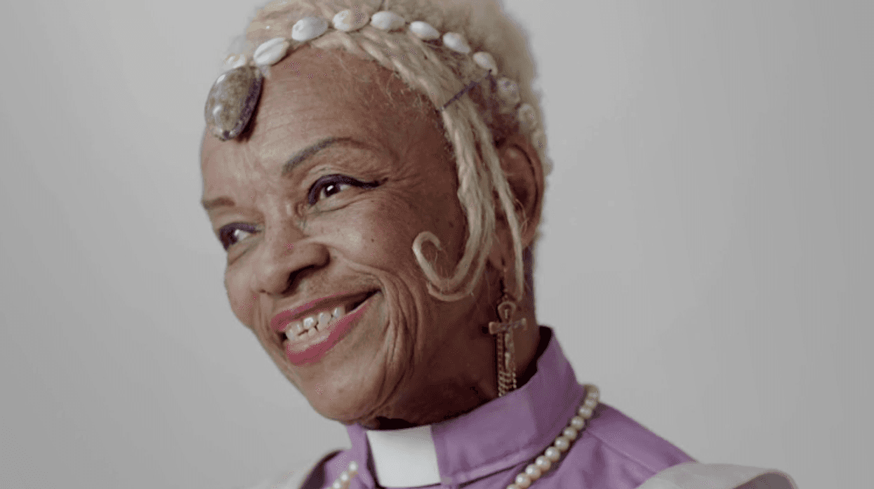 Magora Kennedy, a Black woman with blonde hair smiles radiantly