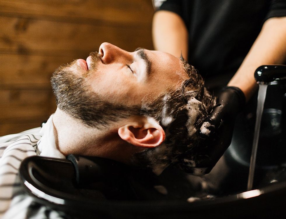 man getting his hair shampooed washed at the salon