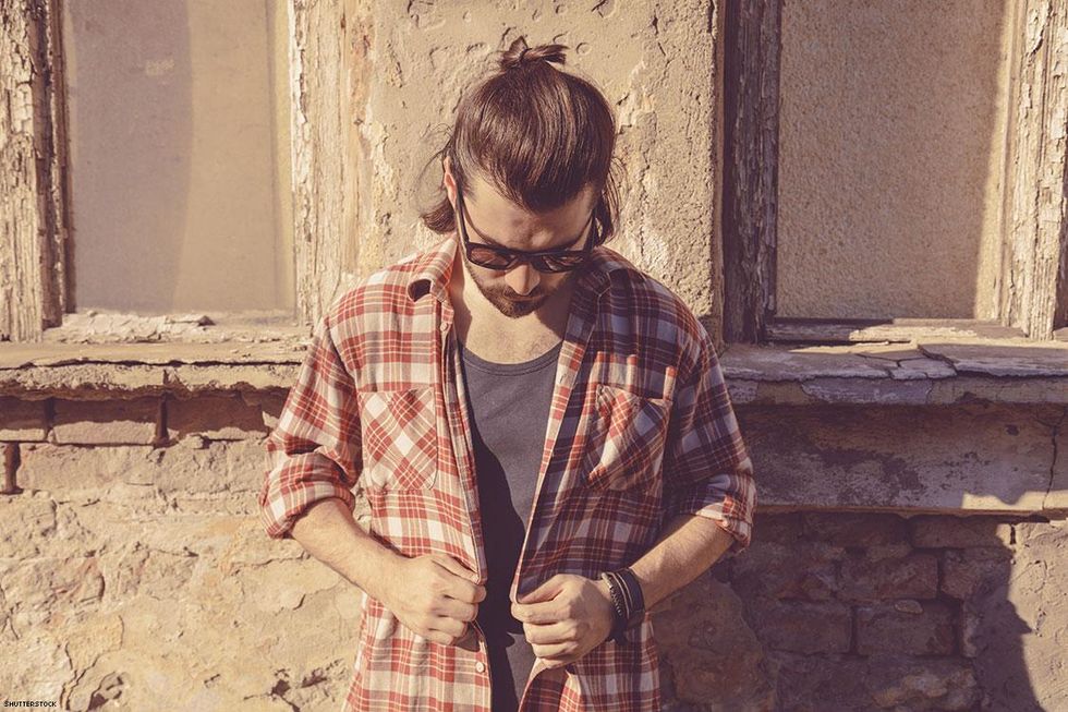 man in flannel looking down