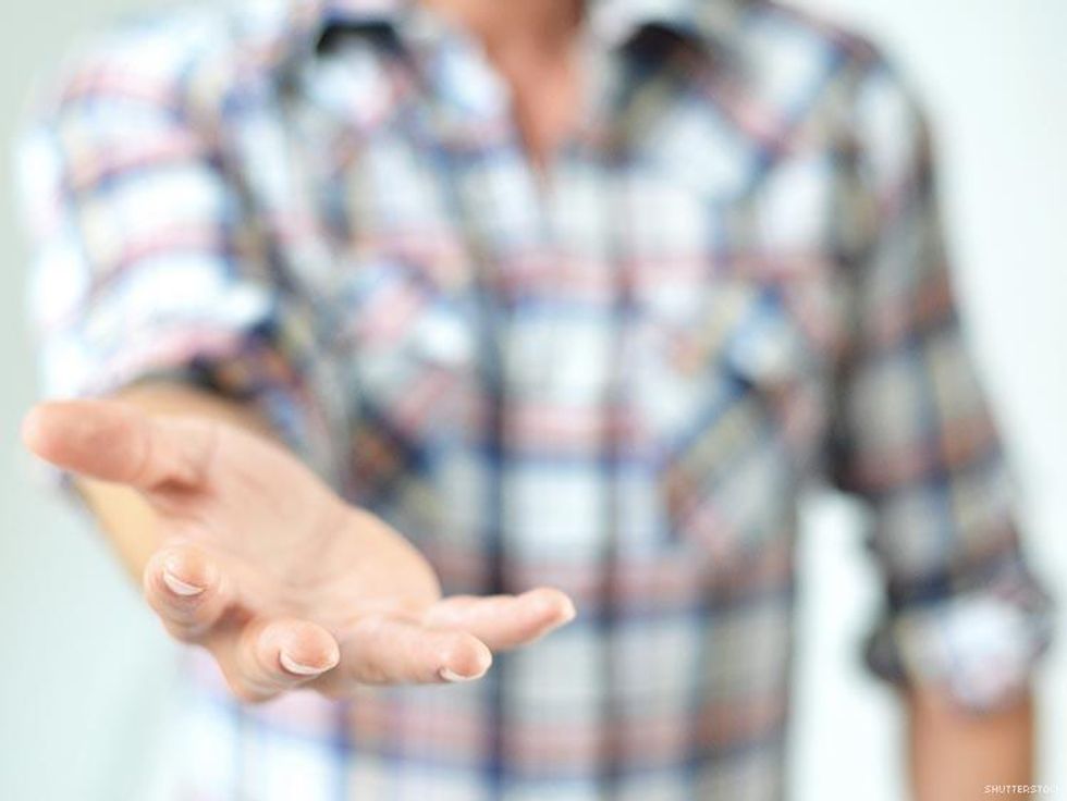 man in flannel shirt reaching out hand