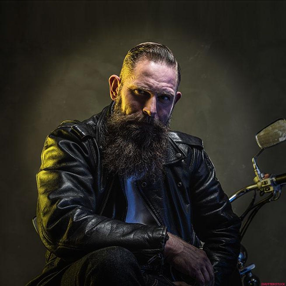 man in leather jacket on motorcycle