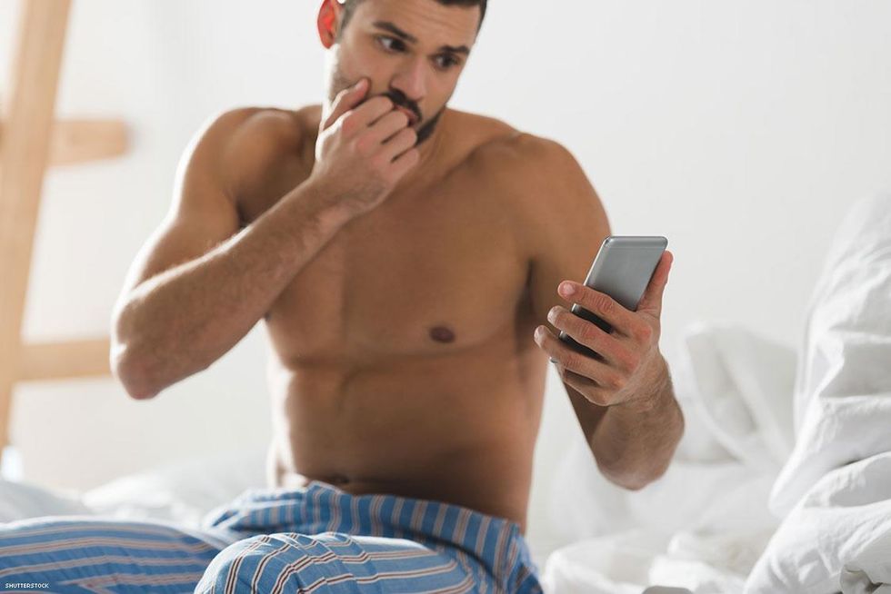 Man in pajama pants looking at his phone