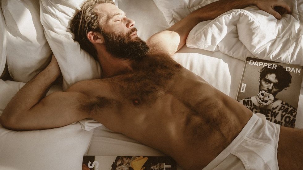 man in underwear on bed