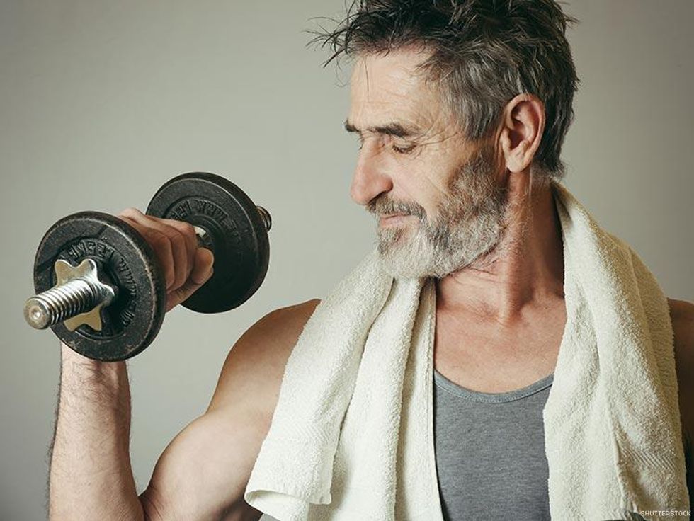 man lifting dumbell making muscle