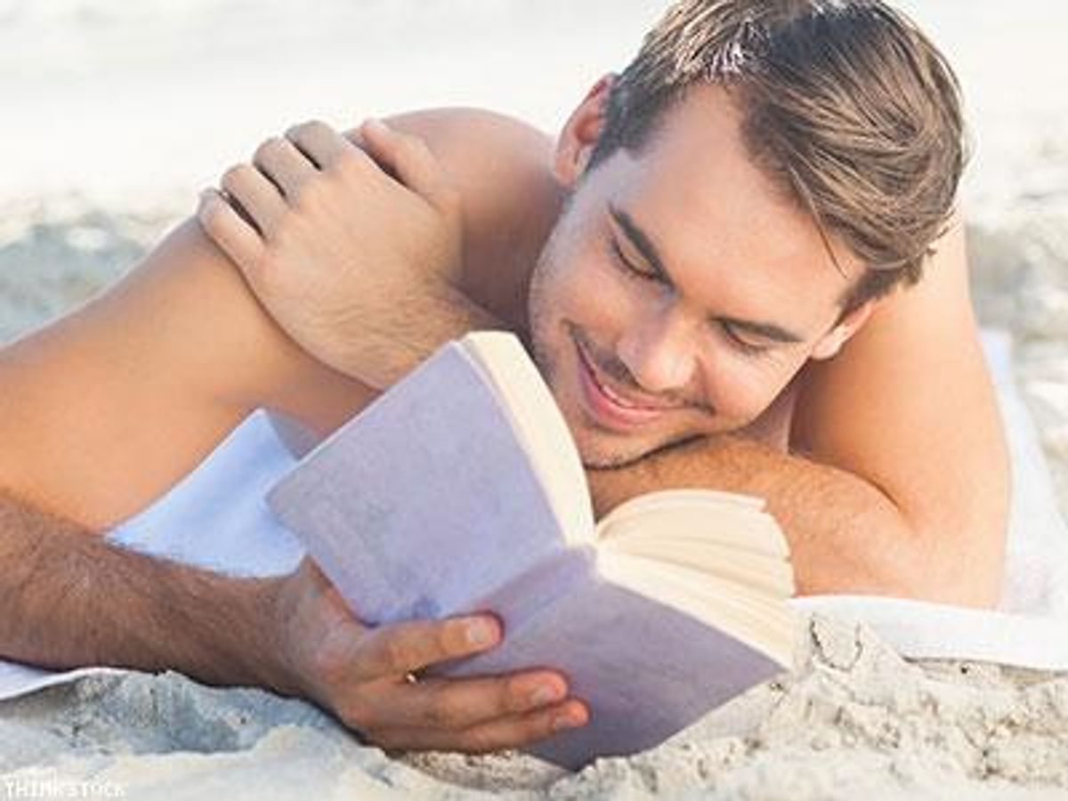 Man-reading-book-on-beach-x400