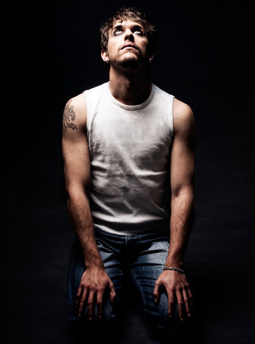 man sitting on floor looking up