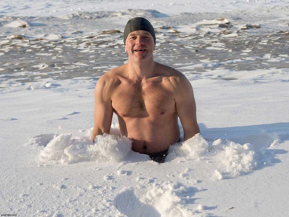 man swimming in winter