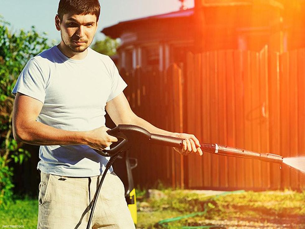 man using a garden hose
