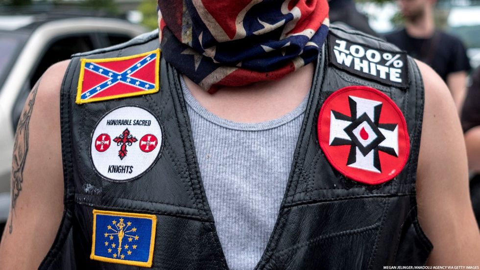Man with hate symbols on his vest