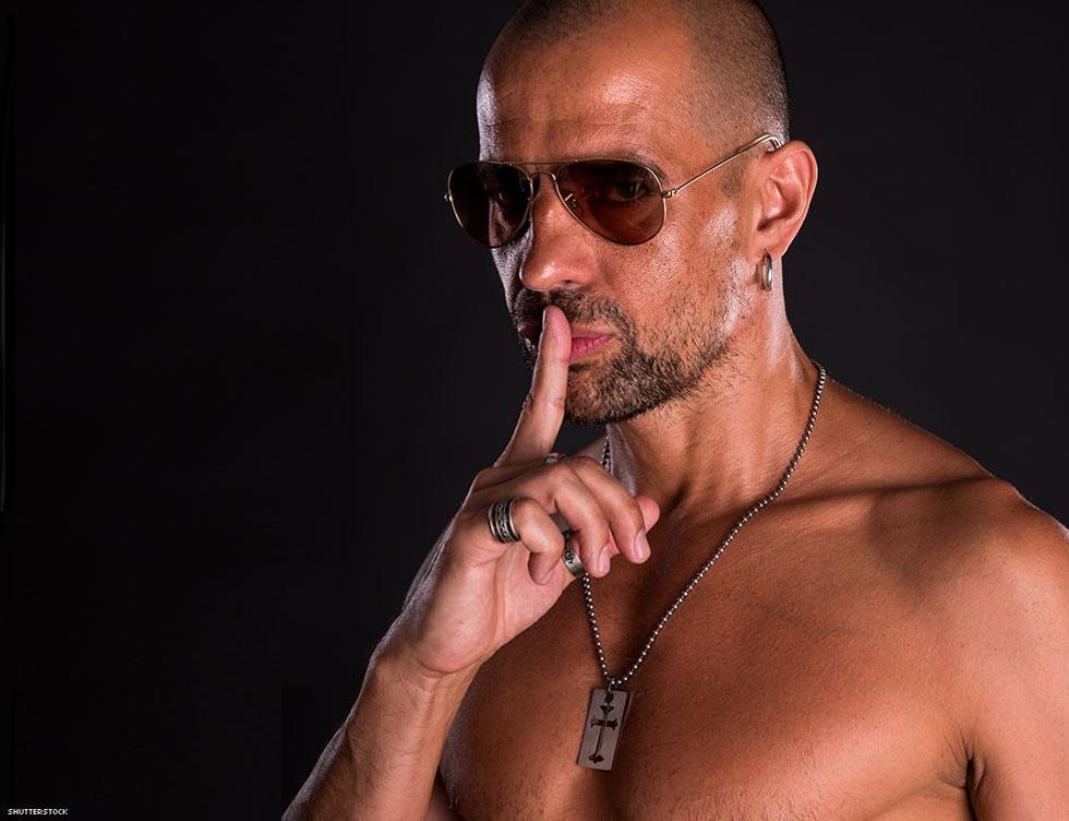 man with sunglasses making shhh motion