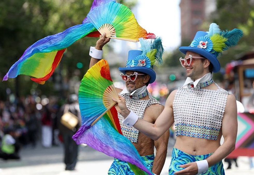 Marchers hold Pride flags as they participate the 52nd Annual San Francisco Pride Parade and Celebration on June 26, 2022